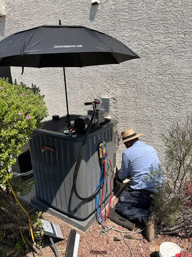 HVAC technician performing outdoor AC maintenance in Donna